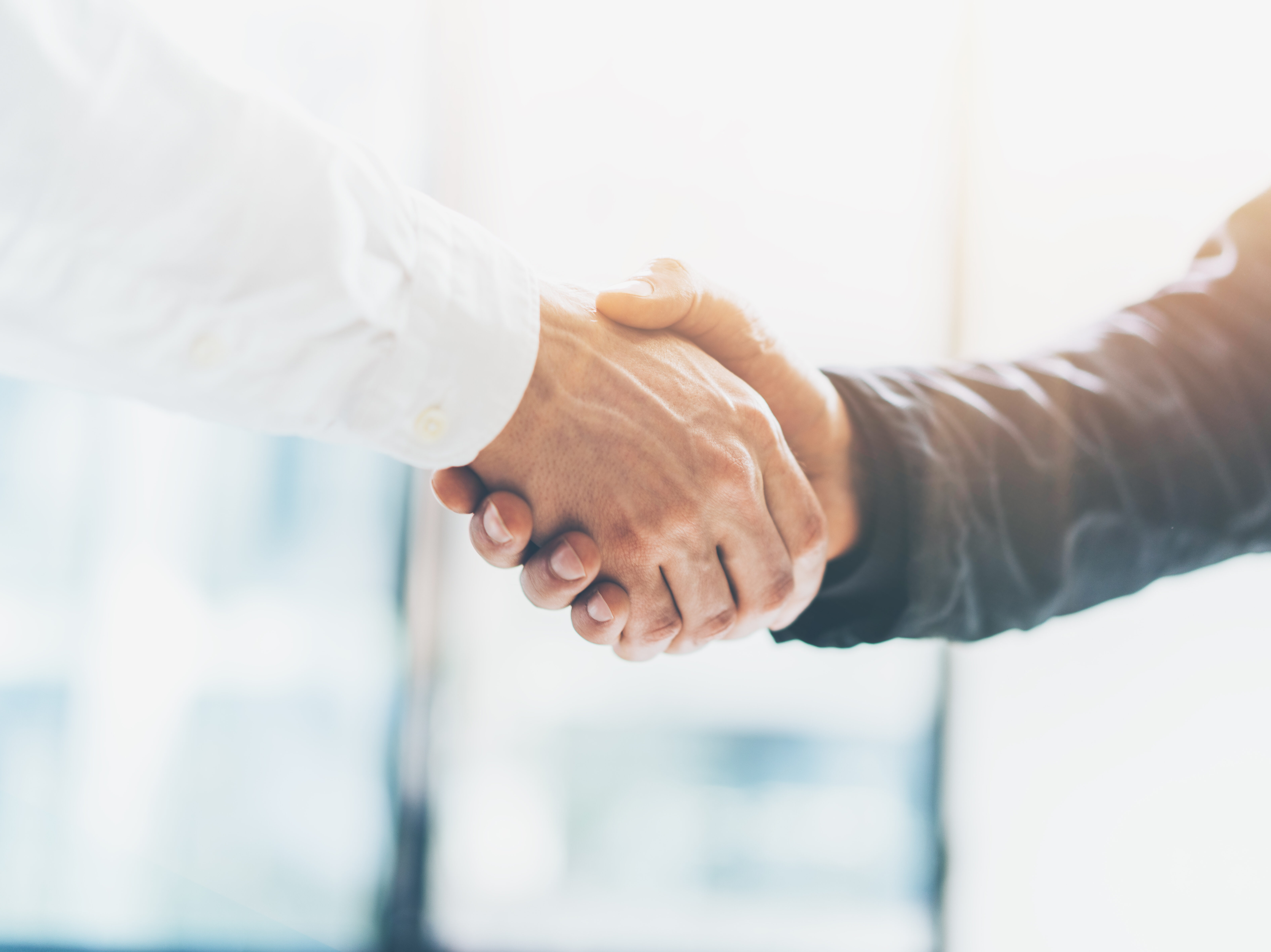 Business partnership meeting. Picture businessmans handshake. Successful businessmen handshaking after good deal. Horizontal, blurred background